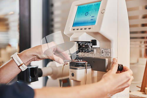 Image of Lens machine, glasses and hands of optometrist for eyeglasses, prescription and vision frames in clinic. Healthcare, ophthalmology and optician working on eyesight, eye care and medical eyewear