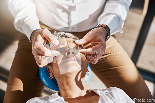 Image of Hands, face or senior woman in eye exam for eyesight at optometrist for an assessment in office. Doctor or optician helping a mature customer testing or checking vision, iris or retina visual health