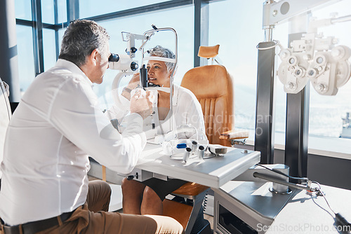 Image of Doctor, eye exam or mature woman consulting for eyesight at optometrist or ophthalmologist. Senior customer testing vision with optician helping or checking iris or retina visual health in office