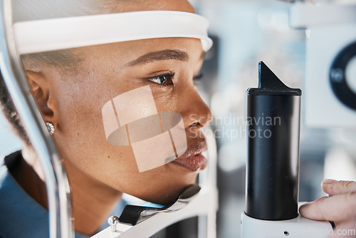 Image of Ophthalmology, eyecare and woman doing eye test at a clinic for optic wellness, health and vision. Medical, optometry and African female patient doing optical exam for prescription lenses in a store.