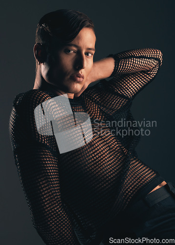 Image of Gender neutral person, fashion and style in portrait on dark background, trendy and edgy. Creative, gen z and beauty, lgbtq and queer with cosmetics, serious and non binary with designer clothes