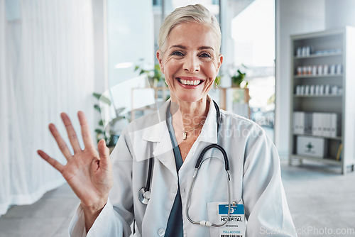 Image of Video call, smile and wave, portrait of woman doctor in hospital office, communication and success in medical work. Health, medicine and face of confident mature professional and online consultation.