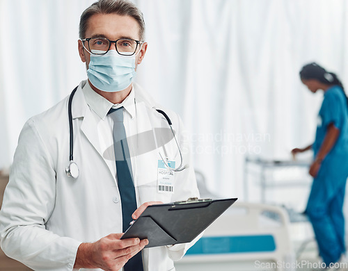 Image of Covid, leadership and portrait of doctor with clipboard, man in hospital for support in medical work. Health, insurance and medicine, mature professional with stethoscope, mask and patient chart.