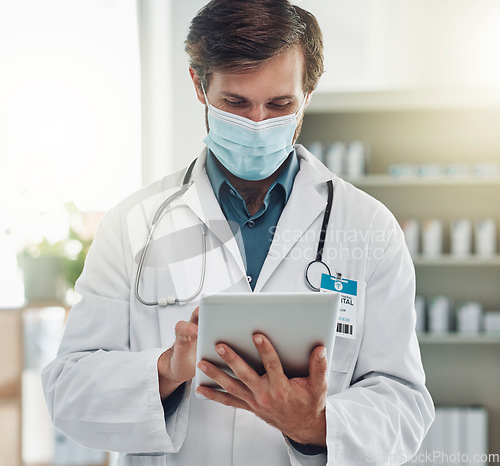 Image of Healthcare, tablet and doctor with mask for medical care, wellness and research analysis in hospital. Covid, insurance and health worker on digital tech for internet, patient data and telehealth app