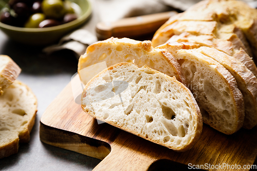 Image of Ciabatta bread sliced on a board, top view