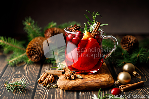 Image of Christmas mulled wine with cranberry, orange, cinnamon, anise and rosemary. Traditional hot drink or beverage, festive Xmas or New Year winter cocktail