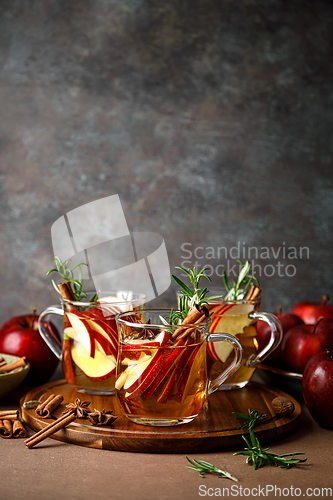 Image of Christmas mulled apple cider with cinnamon, anise and rosemary. Traditional hot drink or beverage, festive Xmas or New Year winter cocktail