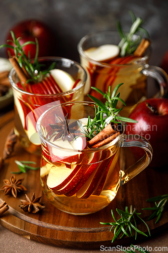 Image of Christmas mulled apple cider with cinnamon, anise and rosemary. Traditional hot drink or beverage, festive Xmas or New Year winter cocktail