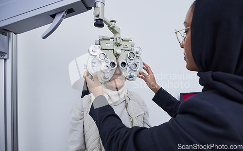 Image of Eye exam, optometry consultation and woman test for medical, healthcare and vision with muslim expert. Eyes check or consulting of senior person and professional optometrist with phoropter machine