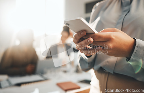Image of Business woman typing, phone text and meeting with a female employee on a mobile app. Office, corporate team and online chat of a financial analytics worker on a cellphone with blurred background