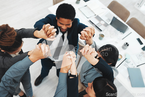 Image of Collaboration, teamwork and above business people holding hands in support of vision, growth or training in office. Team building, group and hand unity in motivation, partnership or corporate startup