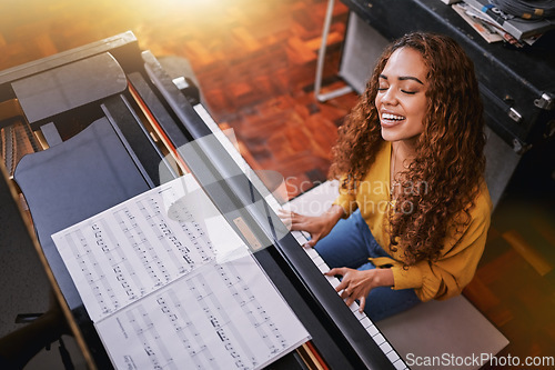 Image of Woman, singing and playing piano with music notes and a smile in home for musician talent and keys. Young person, artist or singer happy about performance and sound of voice and instrument