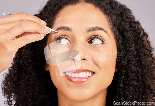 Image of Eyebrow grooming, face tweezer and black woman with wellness, dermatology and facial hair cleaning. Skincare, epilation and clean beauty routine of a young model in a studio doing skin pore removal