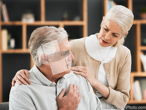 Image of Heart attack, woman stress and senior couple at home with cardiology problem or stroke. House, marriage and retirement of a man with emergency and health issue in a living room with female support