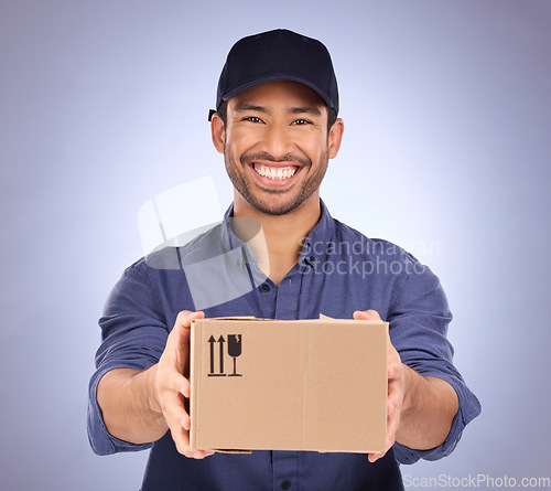Image of Portrait, man and courier with box, happiness and shipping with logistics against blue studio background. Face, male employee and delivery person with package, parcel and mail distribution service