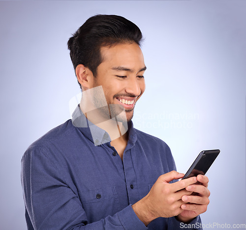 Image of Business asian man, phone and smile for social media, communication or texting against studio background. Happy male smiling on mobile smartphone in networking for chatting, browsing or app on mockup