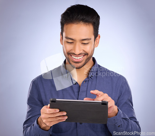 Image of Happy business man on tablet isolated on studio background for stock market research with online app. Happy asian person, worker or entrepreneur on digital technology for profit, sales and fintech