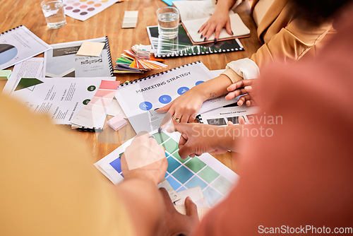 Image of Hands, documents and marketing with a designer team working on a creative project together in the office. Meeting, data and strategy with a group of design people at work in the boardroom closeup