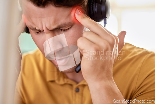 Image of Stress, call center and man with headache, burnout and overworked with pain, overtime and exhausted. Male employee, customer service or consultant with migraine, telemarketing or anxiety in workplace