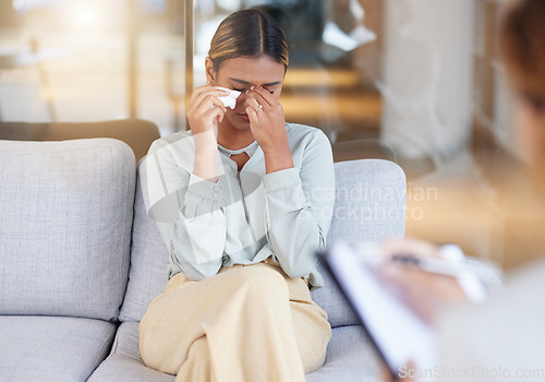 Image of Mental health, woman and employee in therapy session, crying and conversation in office. Female, patient and lady on sofa, depression or counselling for stress, grief or loss with anxiety or recovery
