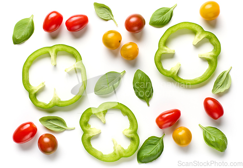 Image of green paprika slices, colorful tomatoes and basil leaves