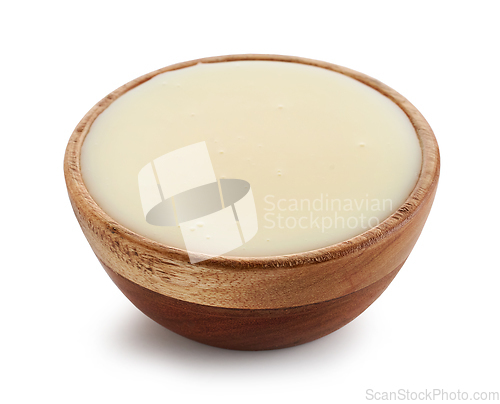 Image of condensed milk in wooden bowl
