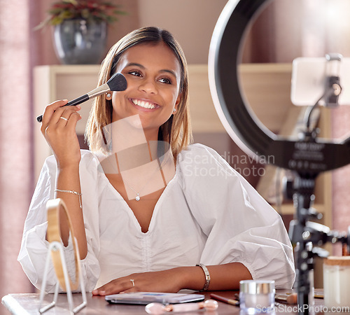 Image of Makeup, influencer and woman record with brush for beauty, cosmetics and cosmetology vlog. Fashion, social media and girl smile, live streaming and filming tutorial on phone with skincare products