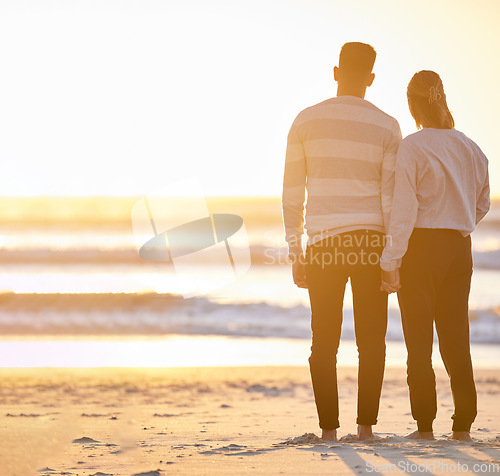 Image of Couple, beach and holding hands at sunset for love and peace with a calm ocean on vacation. Young man and woman together on holiday at sea to relax, travel and connect in nature for freedom mockup