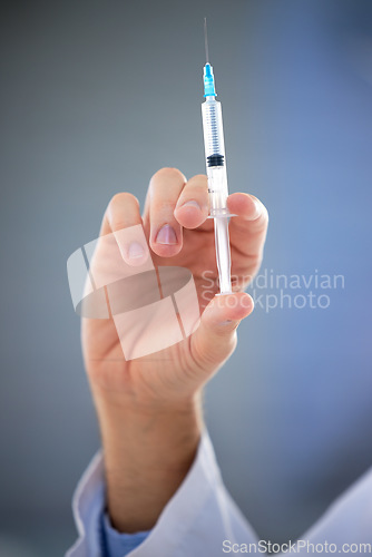 Image of Hand, healthcare and closeup of needle, vaccine or shot for covid, disease or sickness on mockup. Doctor, syringe and zoom on science, innovation or medicine, cure or medical breakthrough at hospital