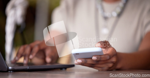 Image of Black woman, hands and laptop with phone for social media, communication or chatting on table. Hand of African American female freelancer in remote work on computer and smartphone for multitasking