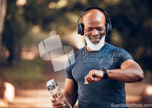 Image of Black man, music headphones and fitness watch with a water bottle and smile outdoor for cardio time. Senior person outdoor with smartwatch for exercise, workout and training for health and wellness