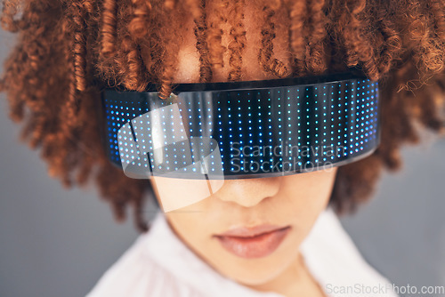 Image of Fashion, cyberpunk and glasses with a black woman in studio on a gray background for futuristic style. Eyewear, future and modern with an attractive young female wearing a trendy or digital visor