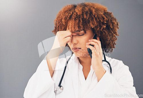 Image of Woman doctor on phone call stress, headache or anxiety for healthcare problem isolated on gray background. Tired, burnout and medical professional or nurse with pain, frustrated or angry on cellphone