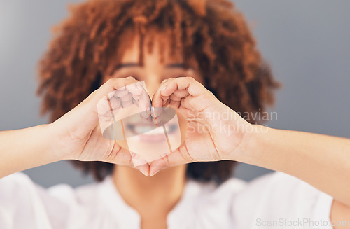 Image of Heart, love and sign with hands of black woman for peace, support and emoji gesture. Confident, happy and smile with girl and self love shape for wellness, happiness or creative in studio background