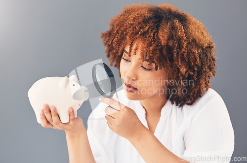 Image of Magnifying glass, piggy bank or black woman with savings budget or financial profits growth on studio background. Curious, cash loan debt or broke girl searching for finances or money investment