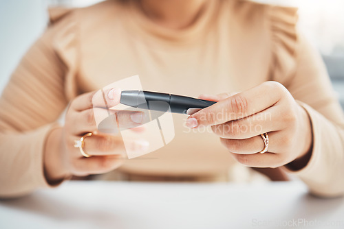 Image of Diabetes, hands of black woman and blood test on finger, healthcare and medicine in home. Health, innovation and technology, diabetic person with digital glucometer checking glucose or sugar level.