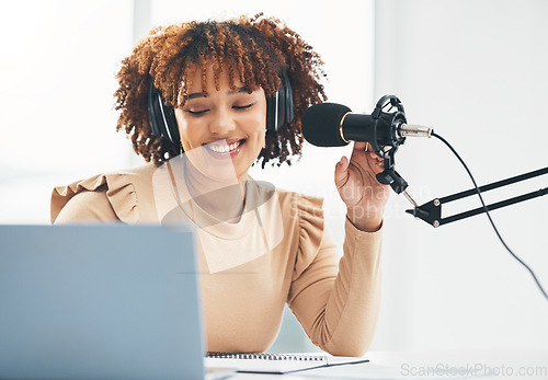 Image of Laptop, microphone and media with a black woman presenter talking during a broadcast while live streaming. Influencer, talk show and radio with a female journalist or host chatting on a mic