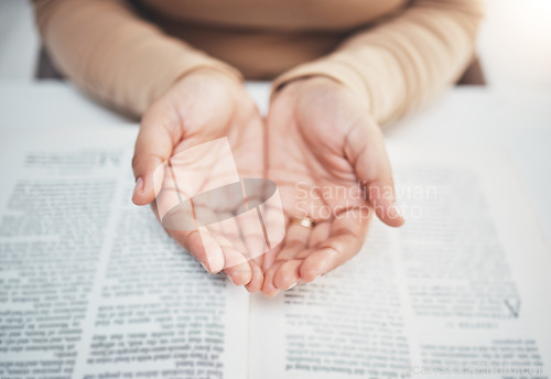 Image of Faith, prayer and bible with hands of woman for religion, support and Christian worship. Believe, spirituality and God with girl praying over catholic holy text for wellness, respect and hope