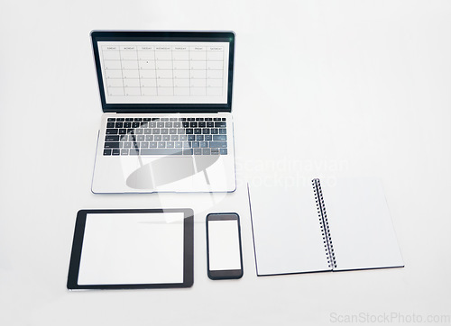 Image of Laptop, tablet and phone mockup with notebook above for schedule planning, advertising or marketing. Computer, touchscreen and smartphone screen display for calendar reminder or organized workspace