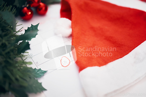 Image of Christmas, preparation and calendar with decorations for the holiday, planning and celebration of an event. Hat, festive and a planner with an important date for xmas, countdown and tradition