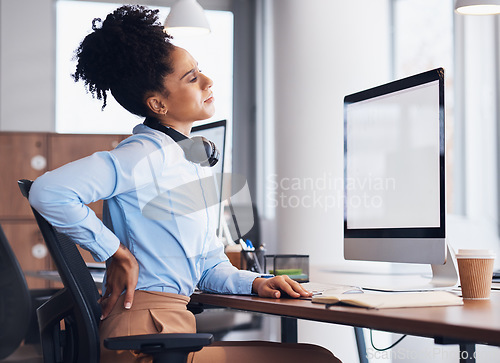 Image of Back pain, call center and business black woman with injury, muscle ache and spine problem at desk. Customer support, telemarketing and tired female worker massage body for strain, tension and stress