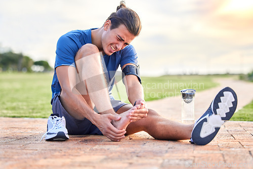 Image of Fitness, injury and foot pain with man in park for muscle spasm, inflammation and joint problem. Running, workout and exercise with athlete and sports emergency for health, suffering and broken ankle