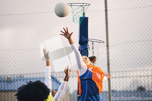 Image of Netball, goal shooting and defense of a girl athlete group on an outdoor sports court. Aim, sport game and match challenge of a black person with a ball doing exercise and training in a competition