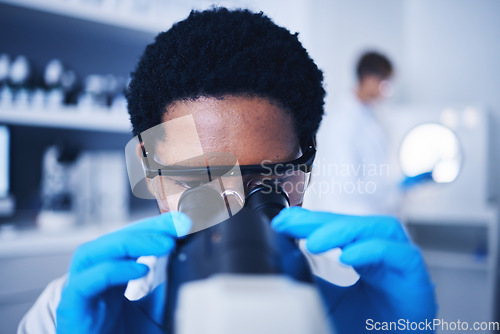 Image of Microscope, science and black man face working in laboratory, medical research or virus analysis. Scientist, microbiology or medical worker check investigation, study innovation or dna pathology test