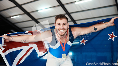 Image of Man, athlete and flag on shoulder with medal, smile and sports for portrait, competition and pride. New Zealand champion, happy and winner with gold, celebrate or success in global gymnastics contest