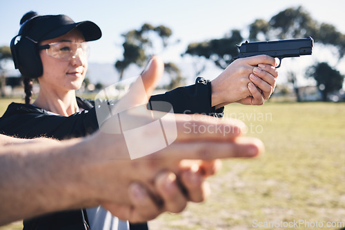 Image of Man, woman and gun training with aim, outdoor target or hand position at police, army or security academy. Shooting coach, pistol or firearm for sport, safety or combat exercise in nature for vision