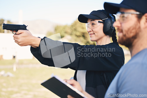 Image of Gun range, target practice and woman holding a rifle for safety, security and police training. Field, exercise, and learning to fire at a outdoor academy with mentor and shooting gear for challenge
