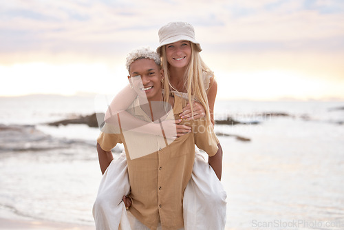 Image of Closeup portrait of an young affectionate mixed race couple standing on the beach and smiling during sunset outdoors. Hispanic man and caucasian woman showing love and affection on a romantic date at