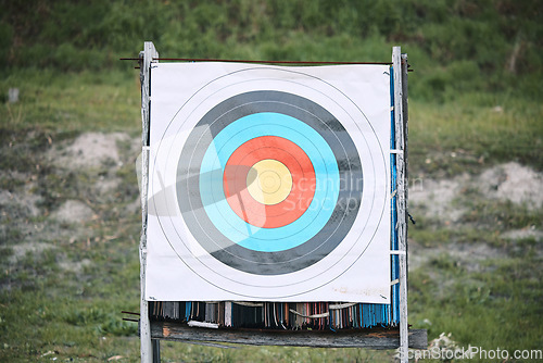 Image of Bullseye target paper, outdoor and board at shooting range for weapon training, aim and accuracy. Sports, archery and poster for gun, bow and arrow at academy for police, army or security for goal