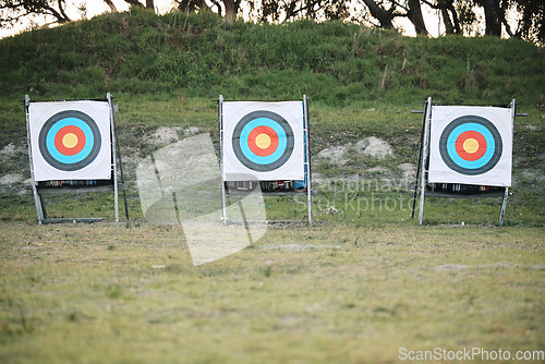 Image of Bullseye target board, outdoor and field at shooting range for weapon training, aim and accuracy. Sports, archery and poster for gun, bow and arrow at academy for police, army or security in nature